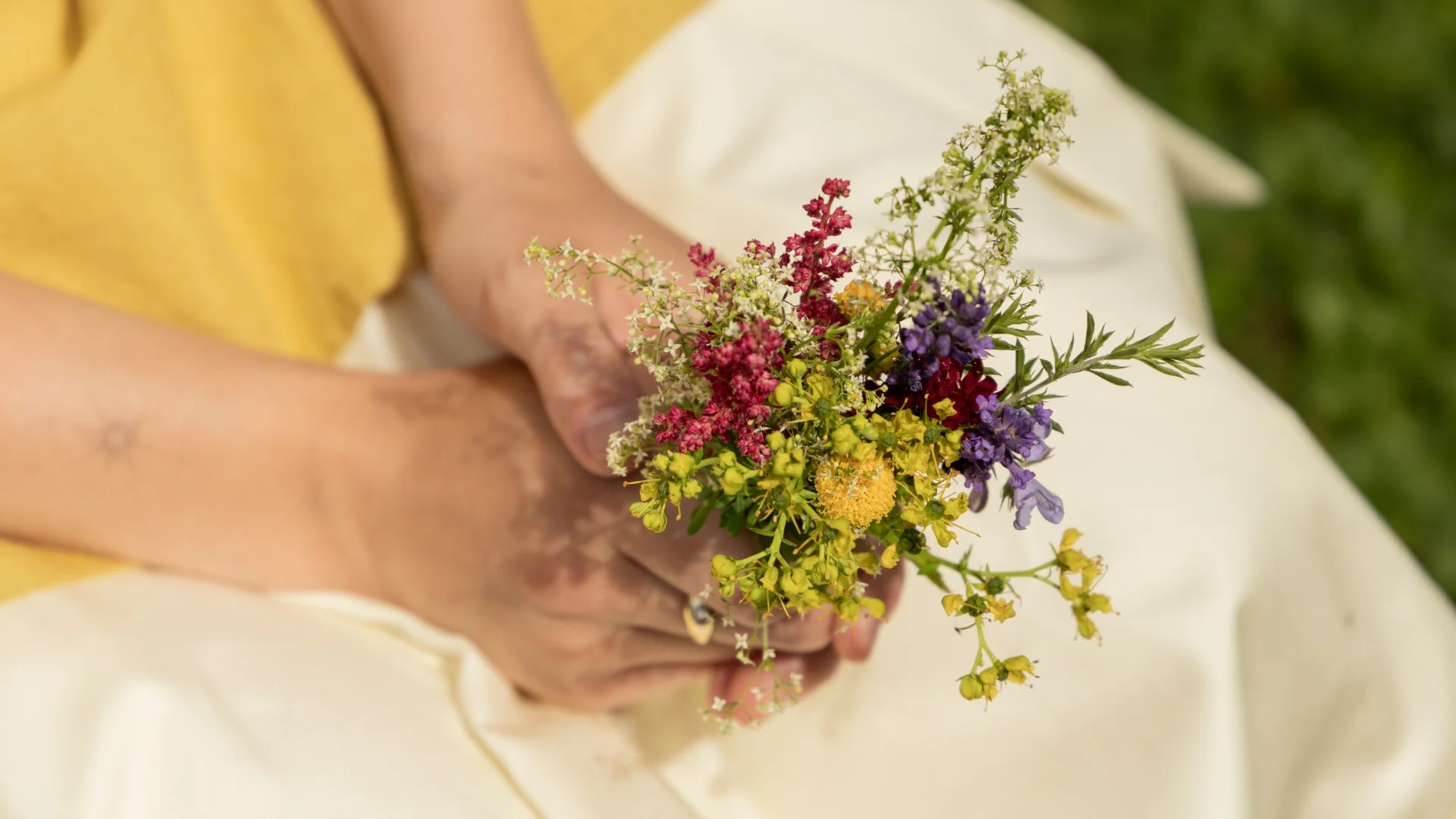 Colour Hunting Sommerchallenge Person hält einen bunten Frühlingsblumenstrauß in der Hand