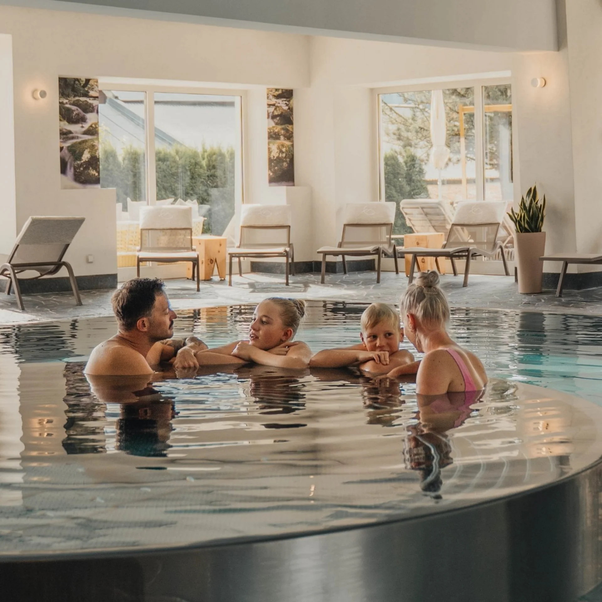 Family with children relaxing in a spa hotel pool