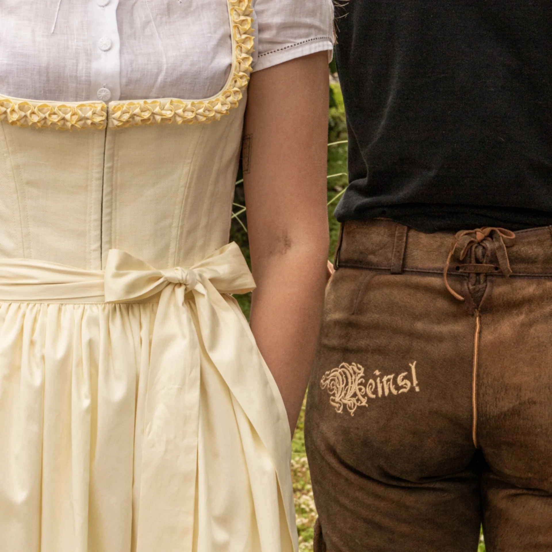 Salzburger Bauernherbst trifft auf Wild-Watching Personen in traditionellen bayerischen Trachten mit Dirndl und Lederhosen